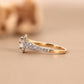 Gold ring with a diamond on a beige background